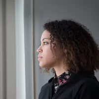 Young person looking out the window.