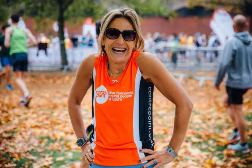 Centrepoint runner posing outside with crowds in background.