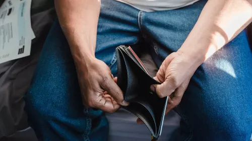 Person holding open an empty wallet