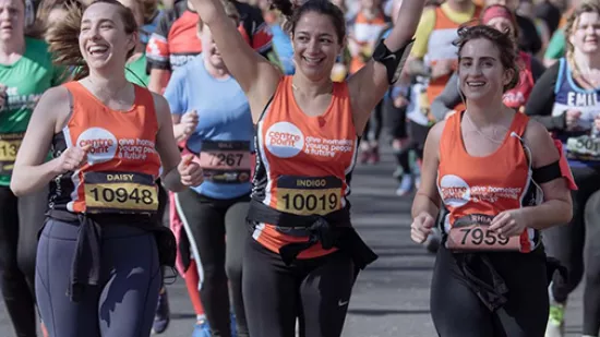 People running in Centrepoint orange vests