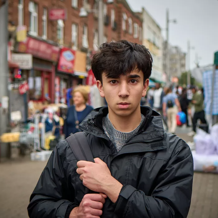 Carim in a busy street clutching his bag