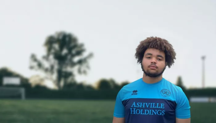 Young person outside wearing a football top