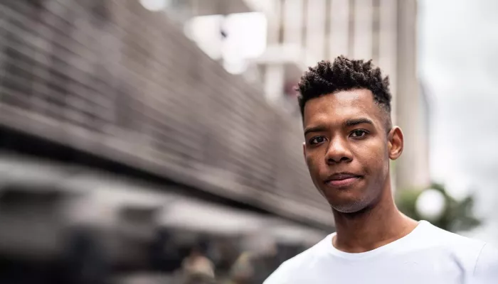 Young person standing outside in white T-shirt