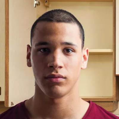 Young person in kitchen staring to camera