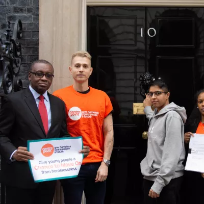 James McVey stands outside 10 Downing Street with Centrepoint residents as they hand in a petition to improve Universal Credit 