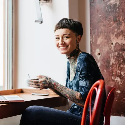 Young person sat at a desk by a window