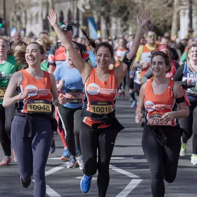 People running in Centrepoint orange vests