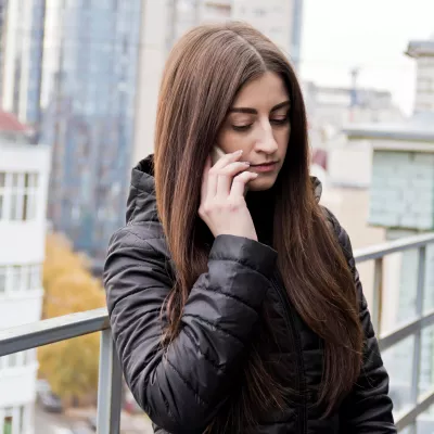 A young woman calls the Helpline.